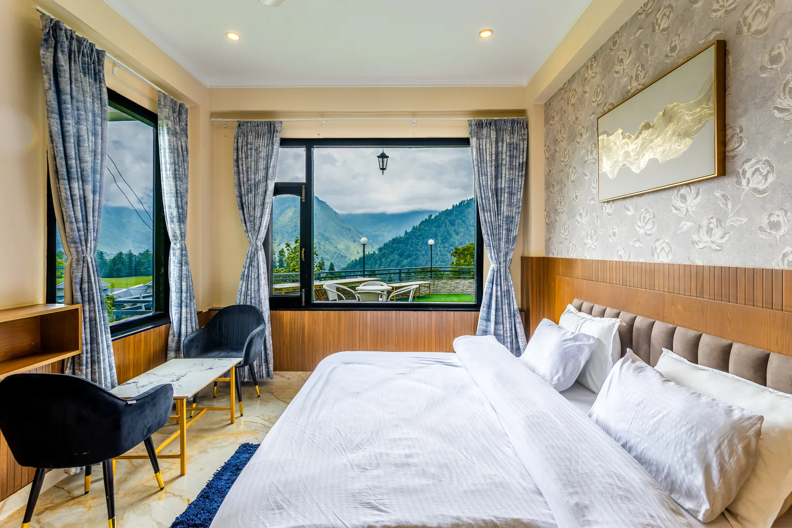 Jr. Suite — king bed with the meadow and mountains through the window