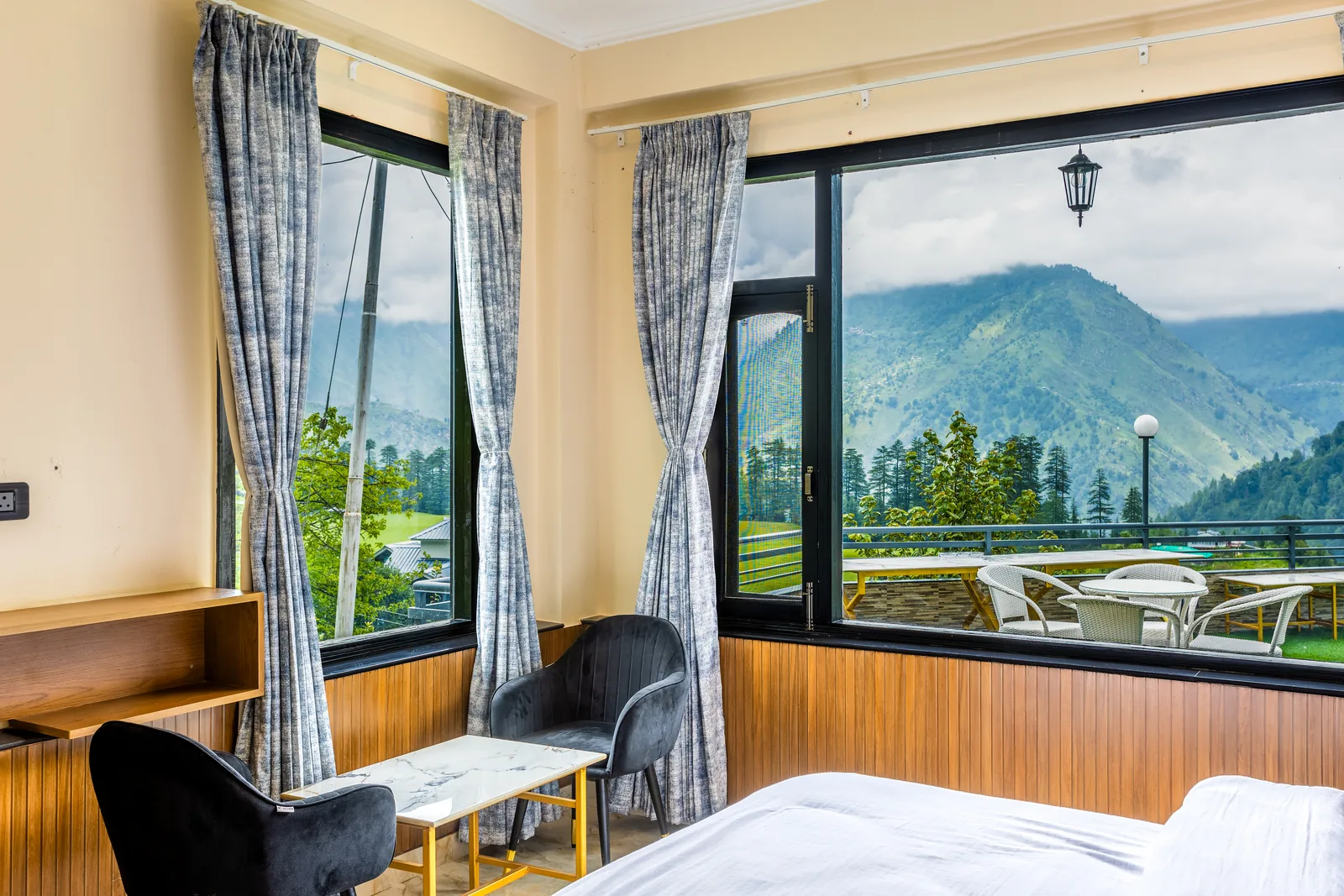 Jr. Suite — window seating with the courtyard terrace beyond