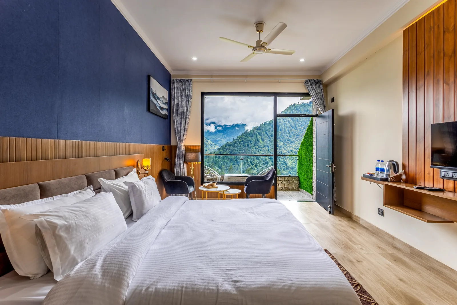 Meadow Suite — bed with the balcony table set beyond it
