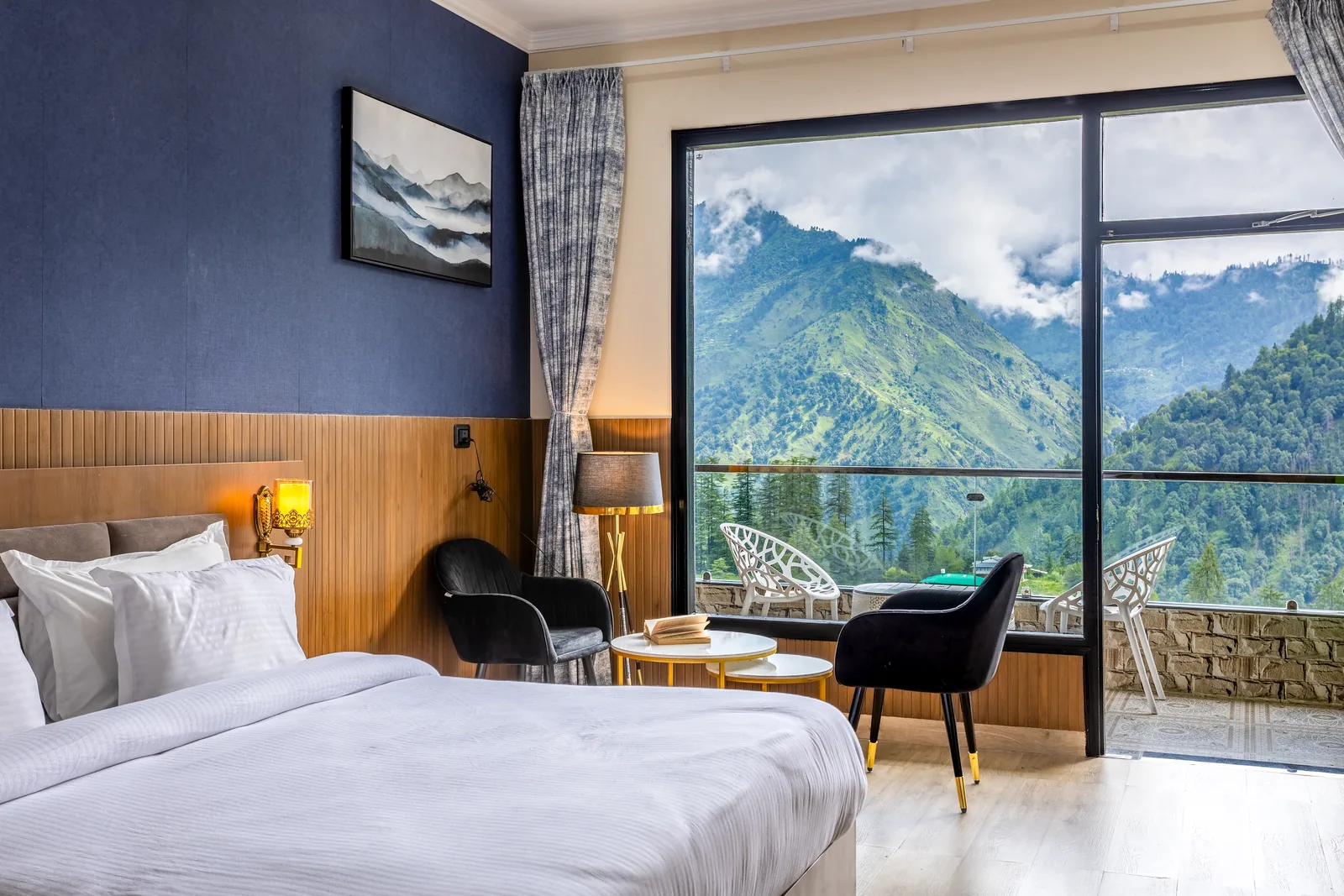 Meadow Suite — bed, seating and the window onto the mountains