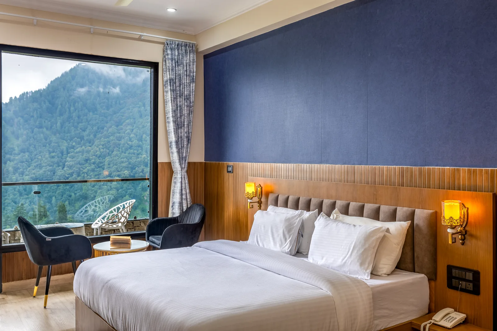 Meadow Suite — bed beside the window, forest beyond