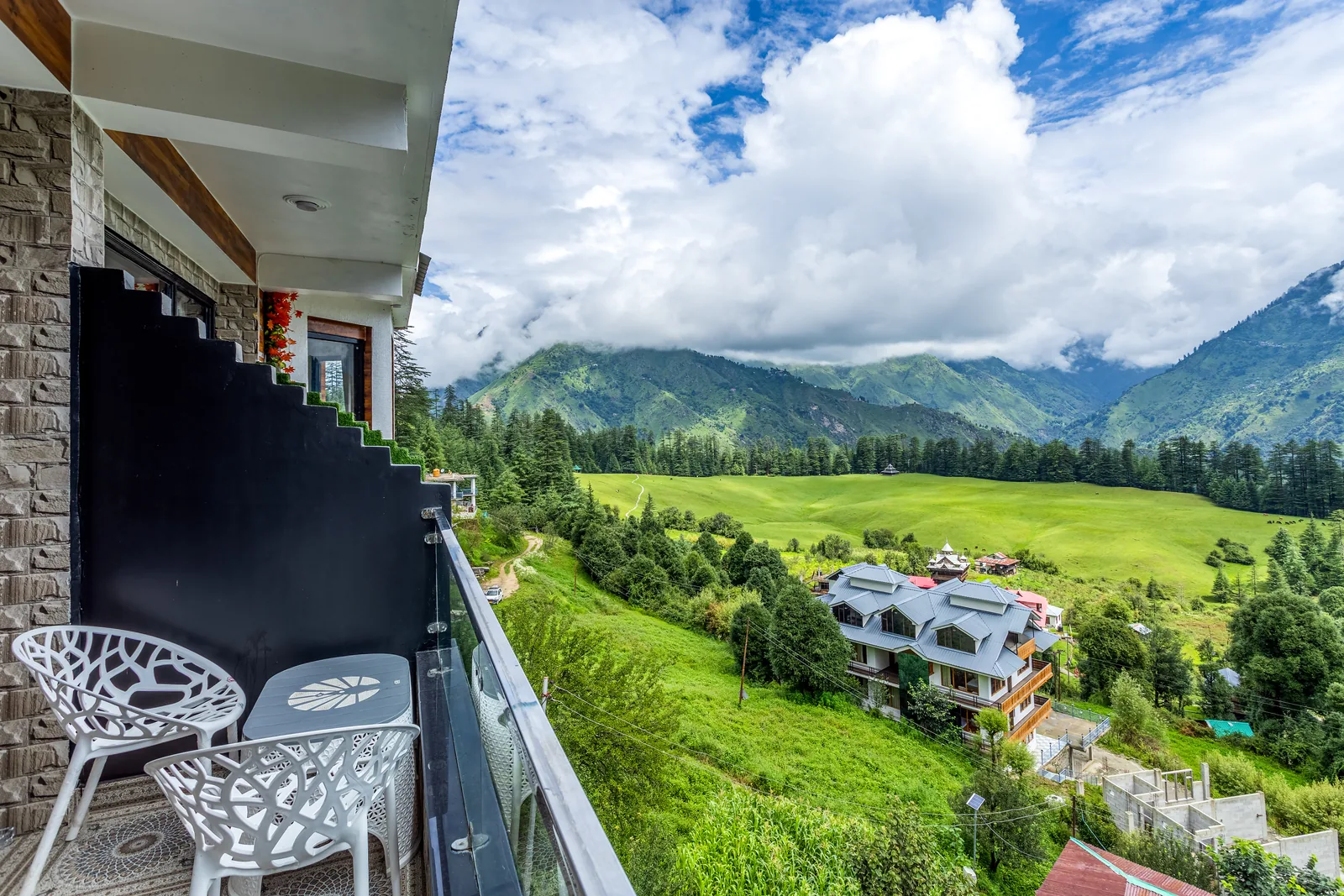 Meadow Suite — balcony seating with the meadow beyond
