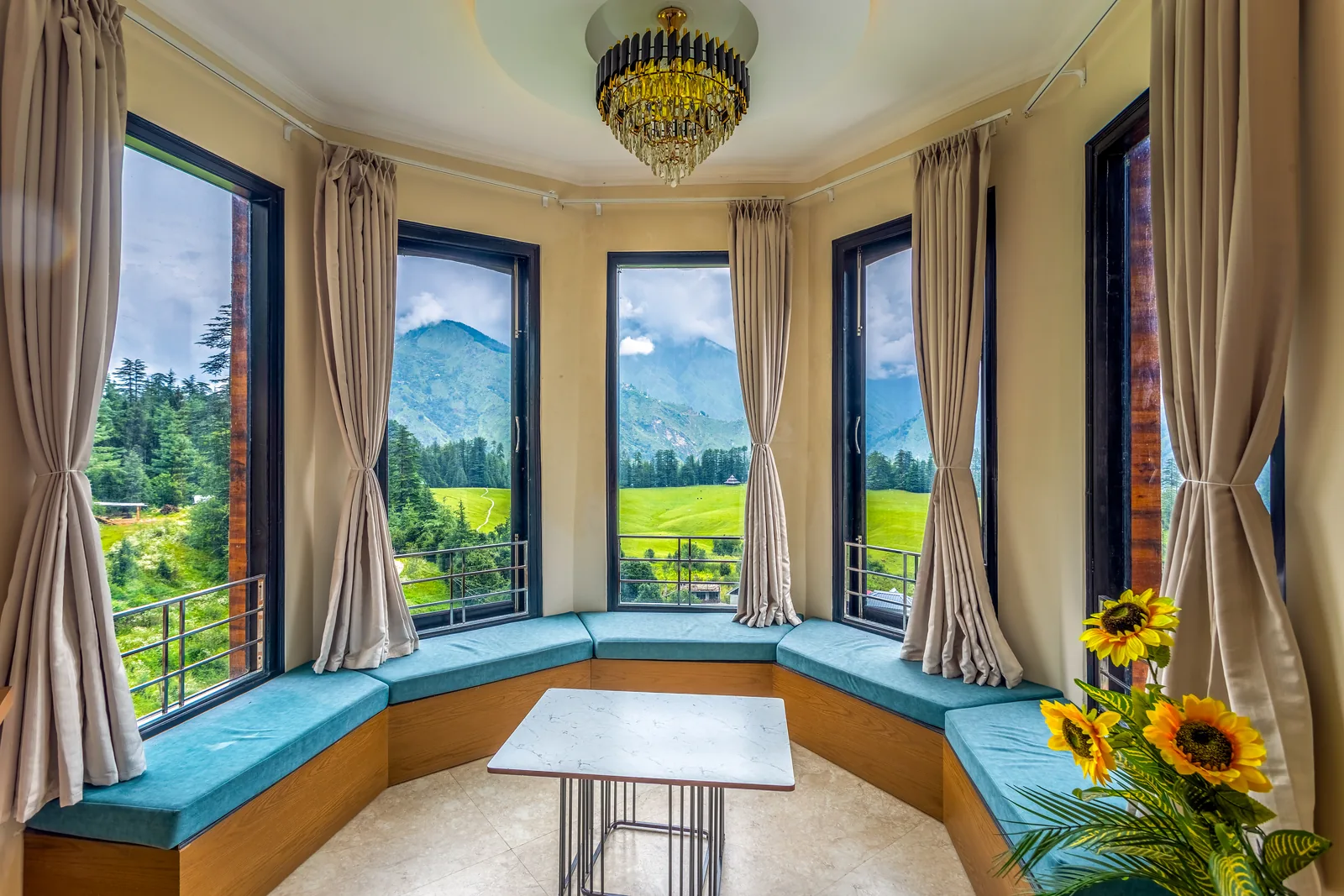 Pavilion Suite — the bay window, five panes onto the meadow, with its curved window seat